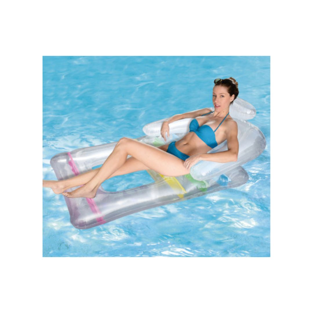 A woman relaxes by the pool on a transparent King Kool Float from Swimming Pool Discounters—buy 1, get 1 free—as she drifts gently atop the clear blue water.