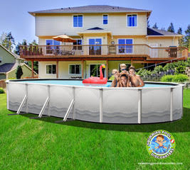 Four kids smile and lean over the edge of an SPD 12' x 24' x 54" Closeout Steel Braced Oval Pool in a backyard, with a large house behind them. A pink inflatable flamingo floats in the above-ground pool.