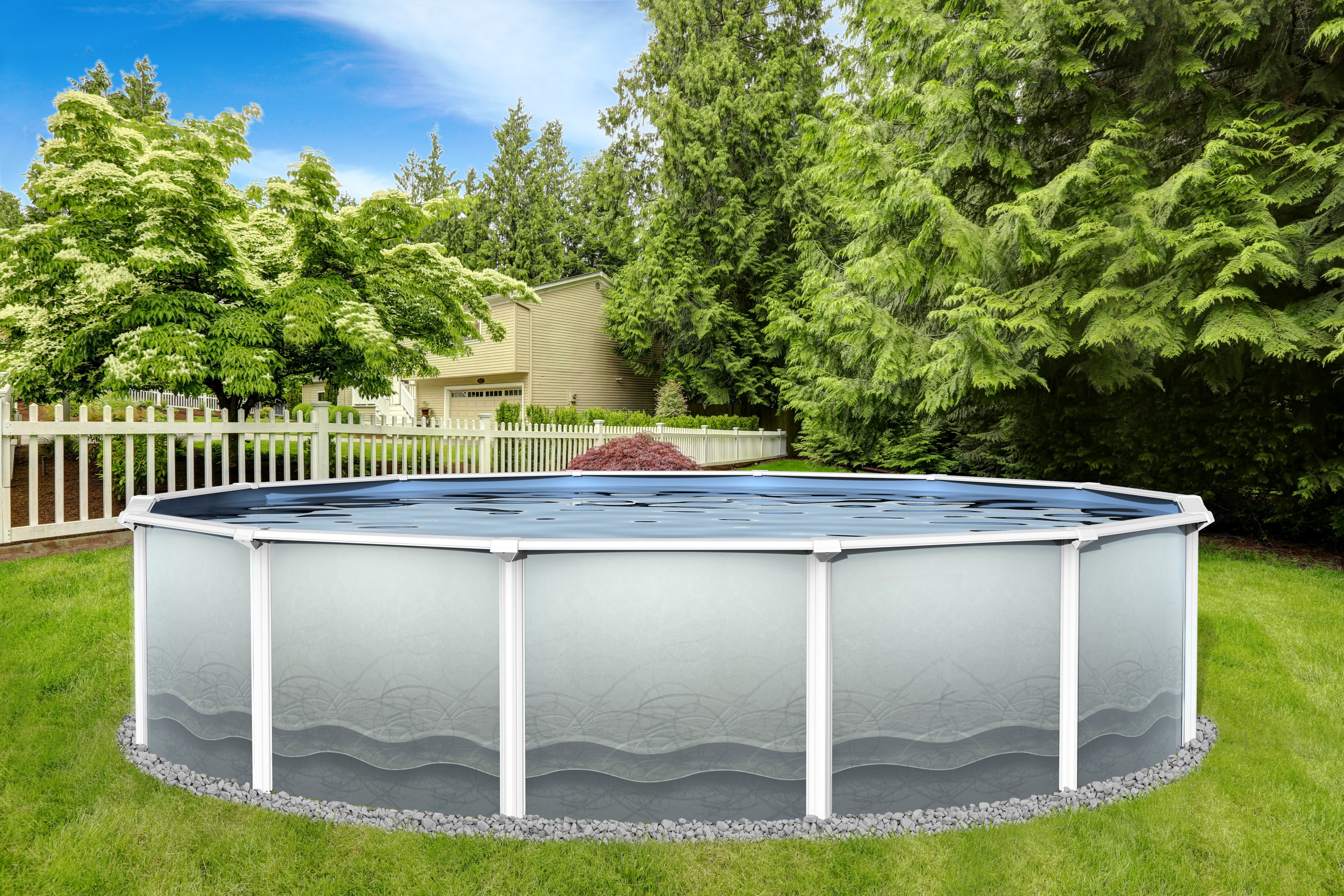 The SPD 12' X 54" Closeout Steel Pool, featuring a rust-resistant, patterned exterior, stands on a grassy lawn surrounded by trees and a white fence, with a house and blue sky visible in the background.