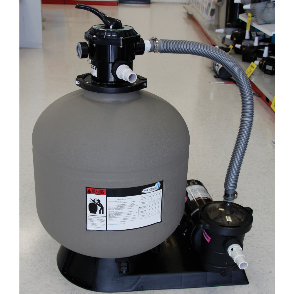 A SwimmingPoolDiscounters 23" Sand Master Energy Saver Filter System with 1.5 HP 2-Speed Energy Saver Pool Pump, hoses attached, is displayed on a black base on a white tiled store floor.