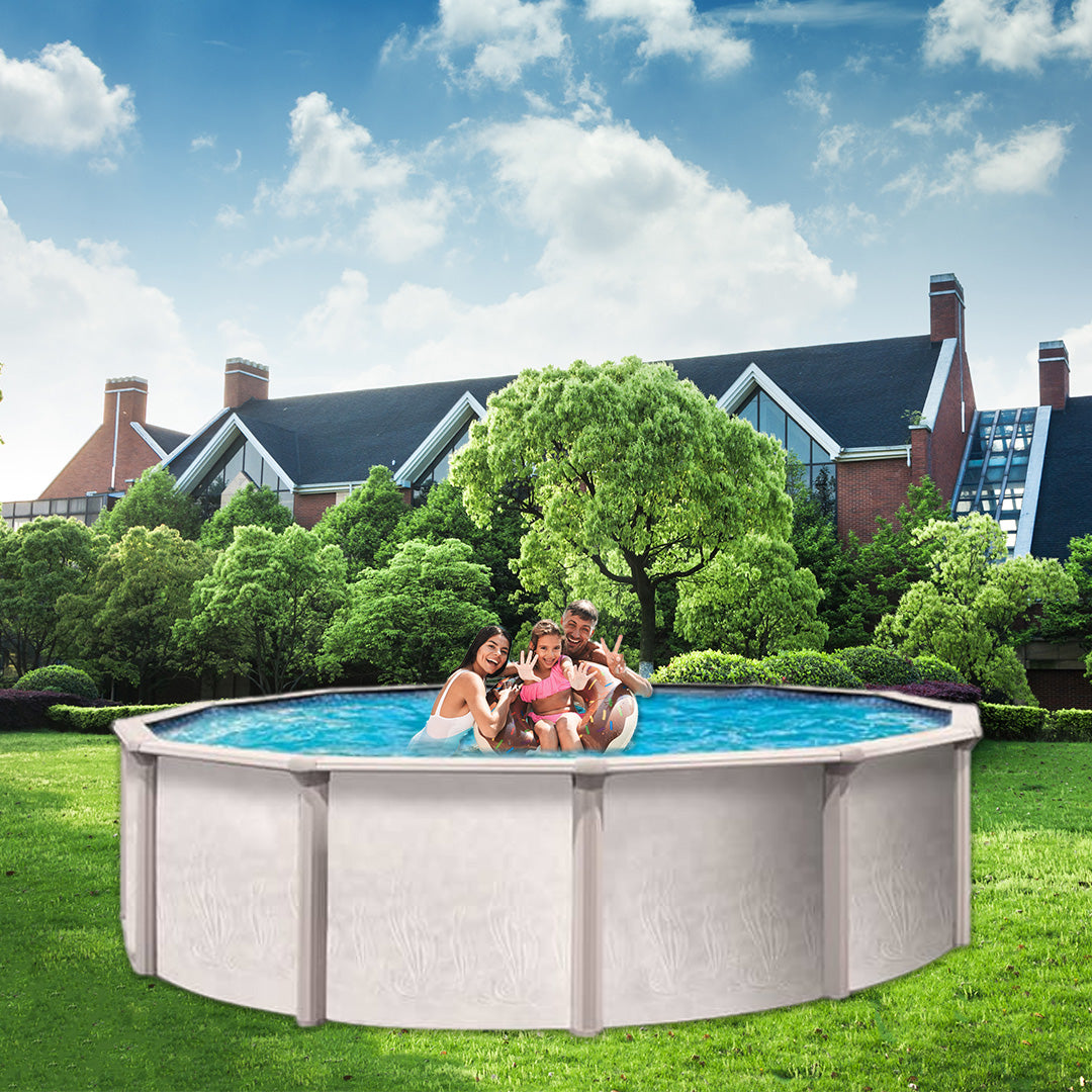A family of three swims in a 15' x 52" Trevi 106 7" Steel Frame Round Pool by Trevi, set on a green lawn with trees and a large building with peaked roofs in the background under a blue sky.